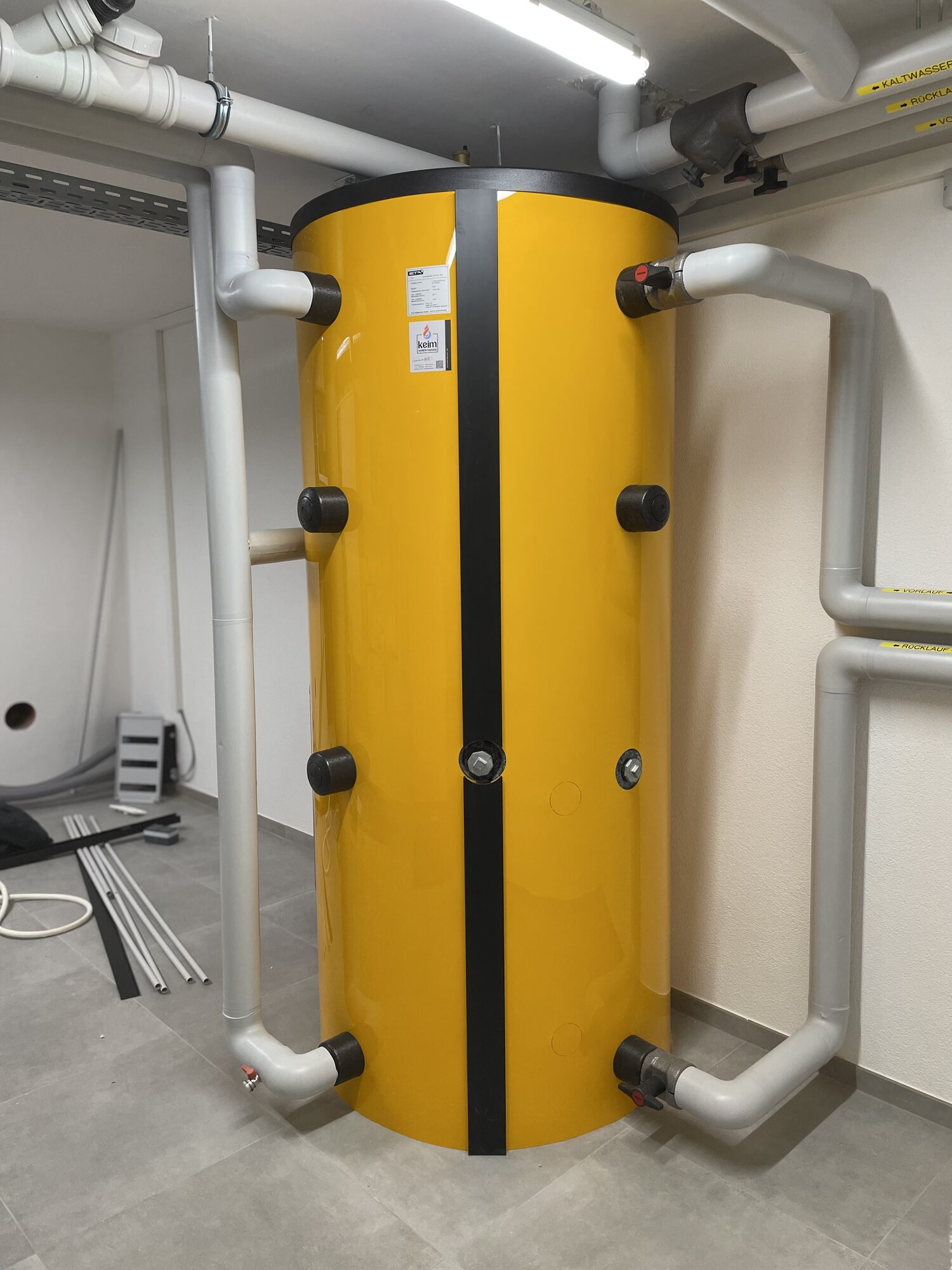 Pufferspeicher mit isolierten Vorlauf- und Rücklaufleitungen im Heizraum